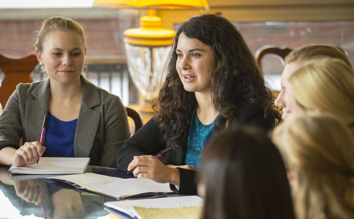 Students participate in a round table meeting